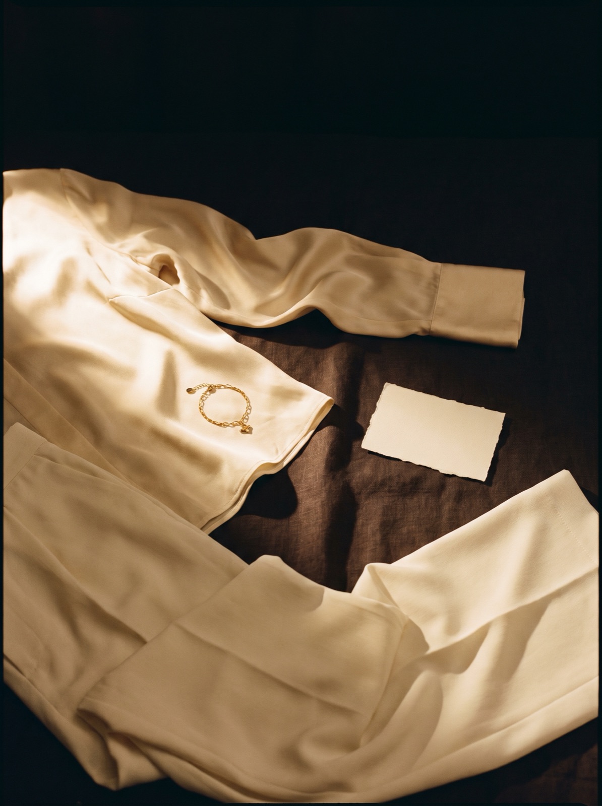 A styled flat-lay on the atelier bench under lamplight